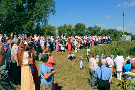 People gathered on the bank for the baptism service. This is a typical way baptisms are conducted in Ukraine.