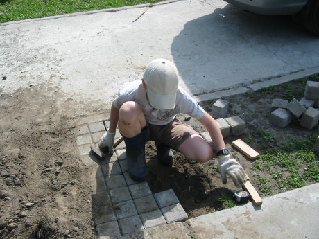 Sashko is busy at work with his sidewalk job