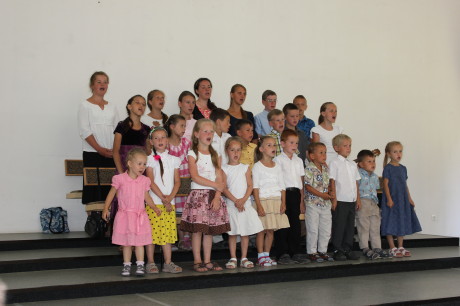 Singing in church the songs they learned at camp