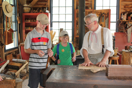 The carpenter at the Conner Prairie teaching Sashko and Yurko