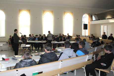 Yura challenging a combined class to get involved in Bible translation in the main auditorium of the local Baptist church.