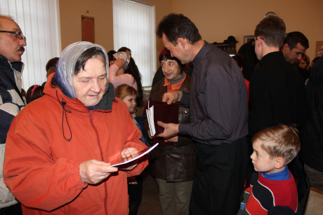 Pastor Roman distributing gospels of Mark and John