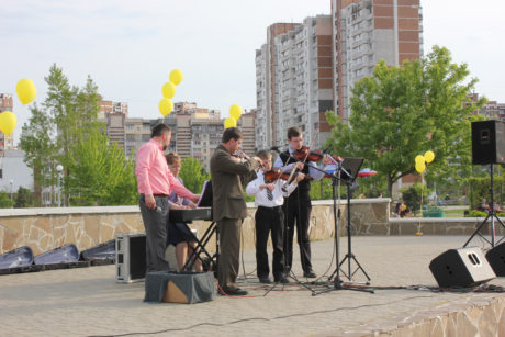 Playing an instrumental at the park evangelism